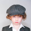 Boy wearing baker boy cap