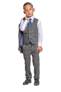 young boy modelling suit with jacket over shoulder