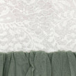 White floral lace curtain panel with a gathered sage green mesh bottom band, shown in a close-up detail shot.