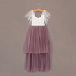 Two-tone dress with white top and heather skirt on a hanger against a brown background