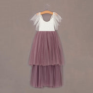 Two-tone dress with white top and heather skirt on a hanger against a brown background
