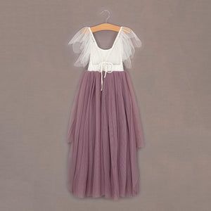 Two-tone dress with white top and mauve skirt on a hanger against a brown background