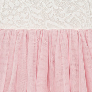 Close-up of pink tulle fabric with white lace in the background
