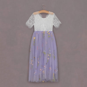 Lace top and floral skirt dress on a hanger against a gray background