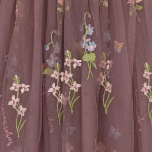 Embroidered floral design on a sheer fabric background