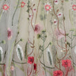 Embroidered fabric with floral patterns on a beige background