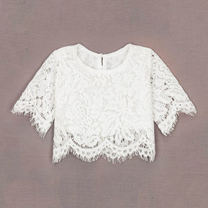 White lace top on a gray background