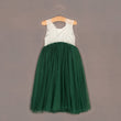 Baby Bohemian Classic Dress - Hunter Green on a hanger against a brown background