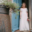 Floor Girl wearing a Flutter Dress in Ivory