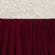 Close-up of burgundy fabric with a textured white lace background