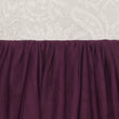 Close-up of a purple textured fabric against a white lace background