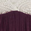 Close-up of a purple garment with white lace trim