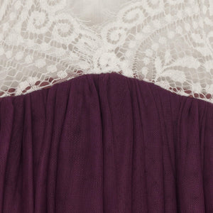 Close-up of a purple garment with white lace trim