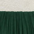 Close-up of green fabric with a textured white background