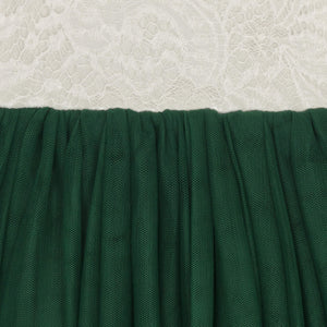 Close-up of green fabric with a textured white background