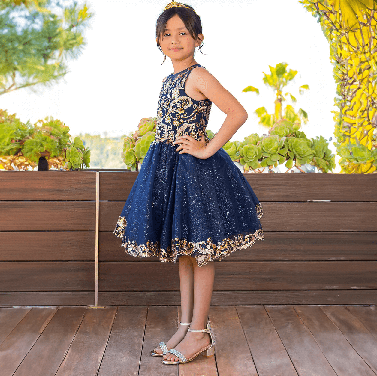 Girl wearing a beautiful navy and gold sequin dress