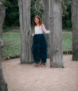 young girl holding to trees
