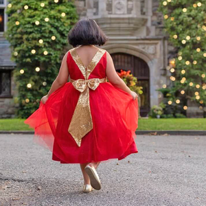 Model wearing red Belle of The Ball Dress with gold bow detail 