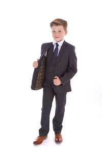 young boy wearing grey suit