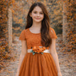 girl in a forest wearing a Bohemian Camilla Dress in Burnt Orange