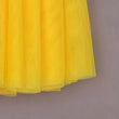 Yellow tulle fabric against a gray background