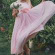 Girl dancing in a pink flower girl dress