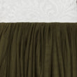 Close-up of olive green fabric against a textured white background
