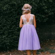 young girl wearing lilac flower girl dress