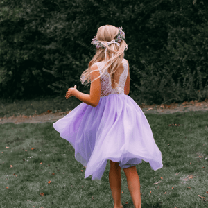 young girl wearing lilac flower girl dress