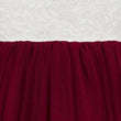 Close-up of burgundy fabric with a textured white background