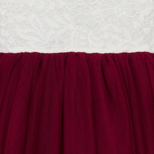 Close-up of burgundy fabric with a textured white background