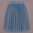 Blue pleated skirt on a beige background