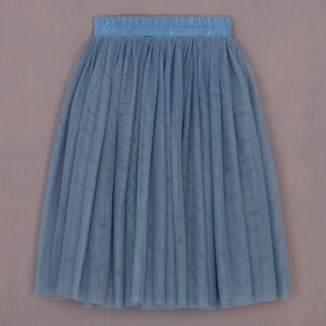 Blue pleated skirt on a beige background