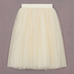 Cream tulle skirt on a plain background