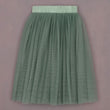Green pleated skirt on a pink background