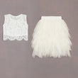 White lace top and tulle skirt on a gray background