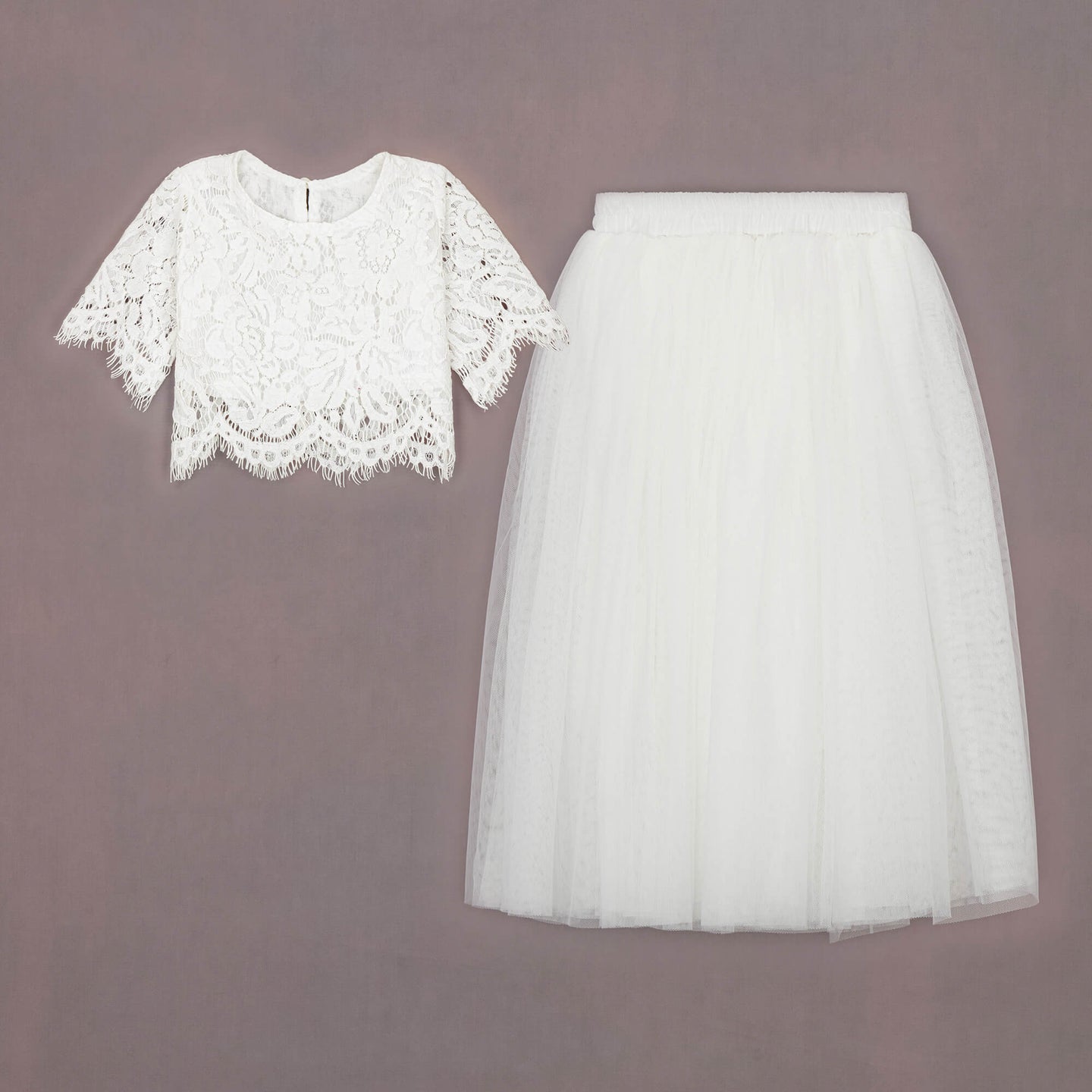 White lace top and tulle skirt on a brown background