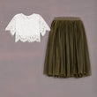 White lace top and green skirt on a gray background