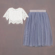 White lace top and blue tulle skirt on a brown background