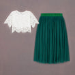 White lace top and green tulle skirt on a gray background