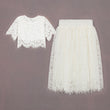 White lace top and skirt set on a gray background