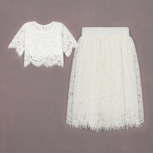 White lace top and skirt set on a gray background