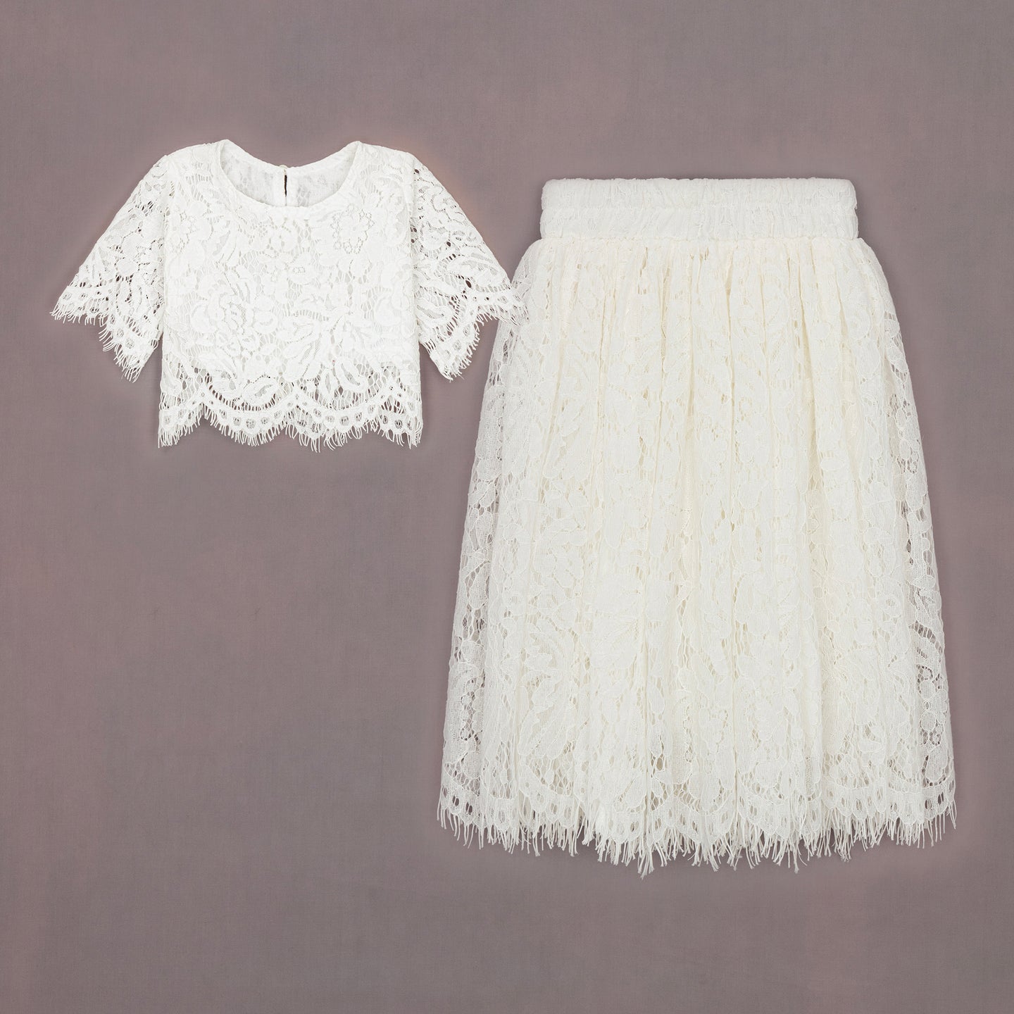 White lace top and skirt set on a gray background