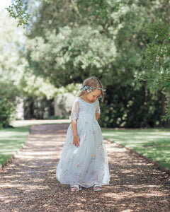 Young girl walking in flower girl dress