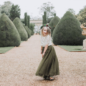 Young girl playing in wedding venue grounds