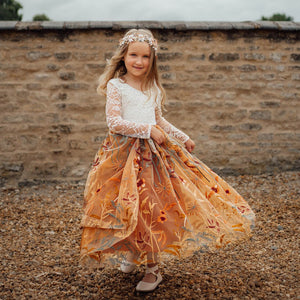 young girl wearing embroidered dress