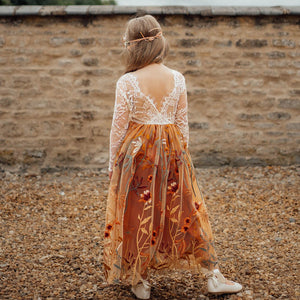 young girl wearing embroidered dress