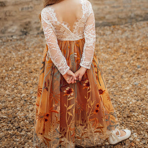 young girl wearing embroidered dress