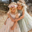 2 girls playing in pretty dresses