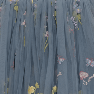 Blue tulle fabric with floral embroidery on a dark background